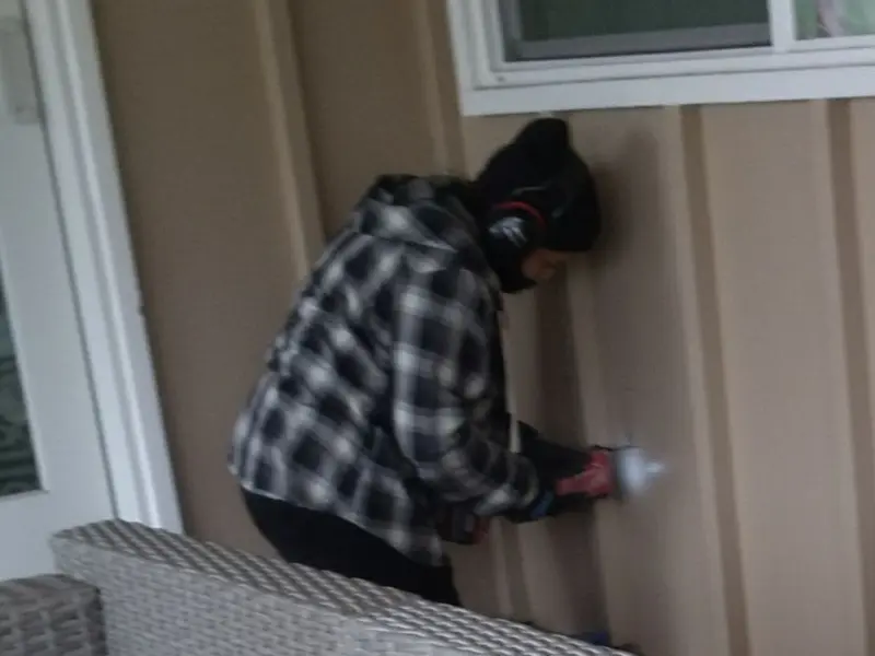 Professional electrician installing an exterior outlet in Ocean
